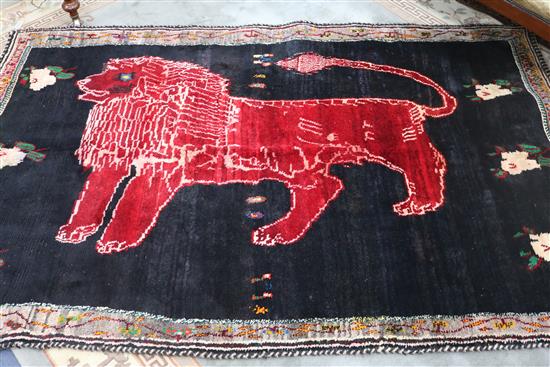 A Shiraz black ground rug, with lion motif, 266 x 163cm